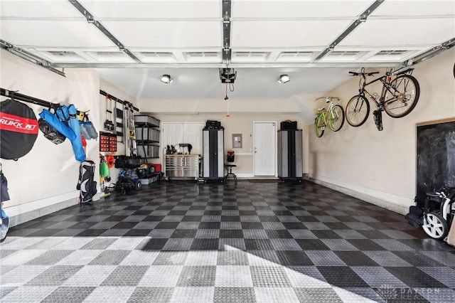 garage featuring electric panel and a garage door opener