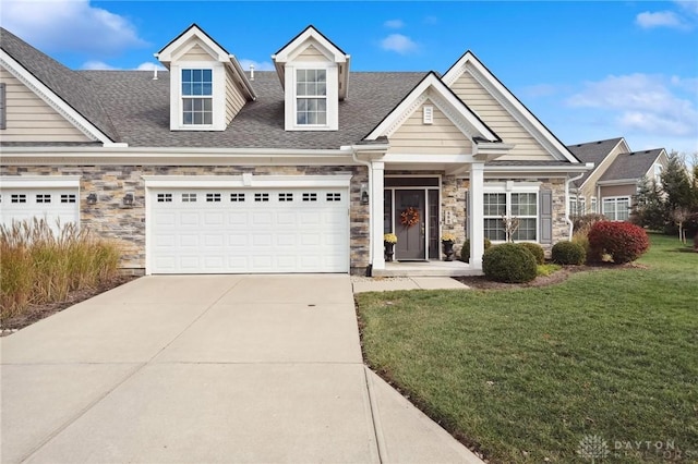 view of front facade featuring a front yard and a garage