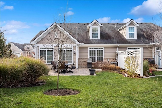 back of property featuring a yard and a patio