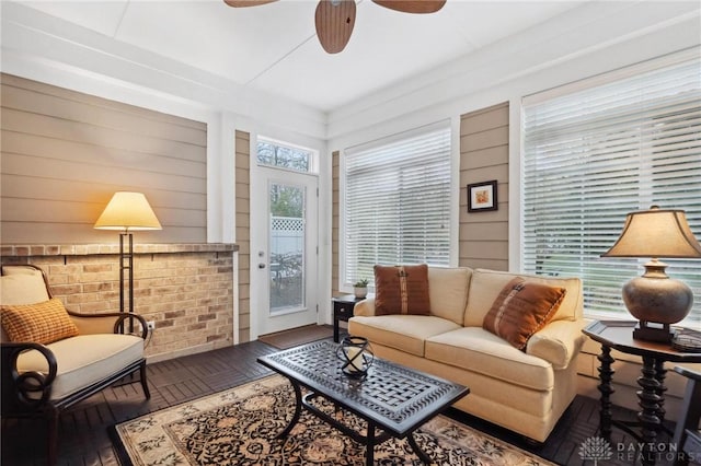 living room featuring ceiling fan and dark hardwood / wood-style flooring