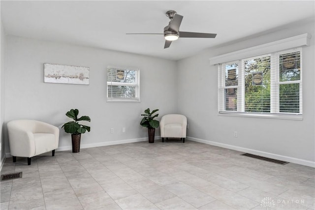 sitting room with ceiling fan and a wealth of natural light