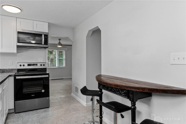 kitchen with white cabinets and appliances with stainless steel finishes