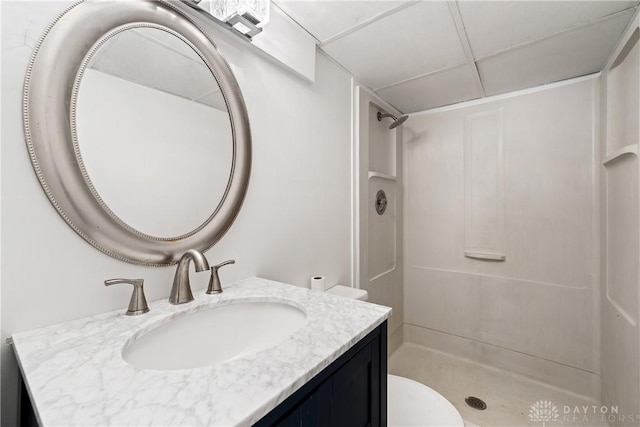 bathroom featuring a shower, vanity, and toilet