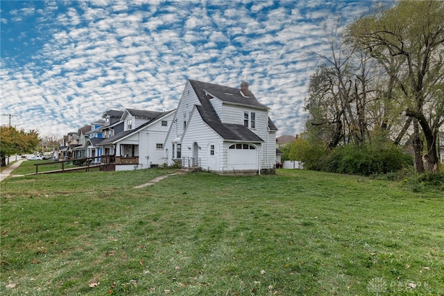 view of side of property with a lawn