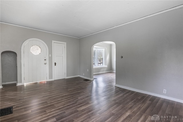 entryway with dark wood-type flooring and ornamental molding