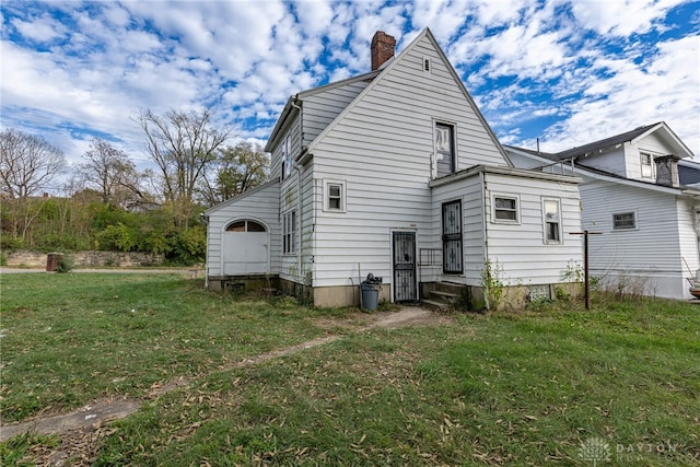 rear view of property with a lawn