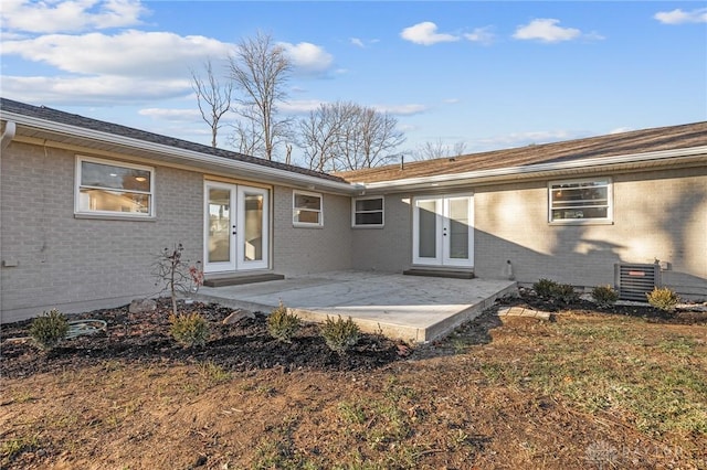 back of house with central AC unit, a patio, and french doors