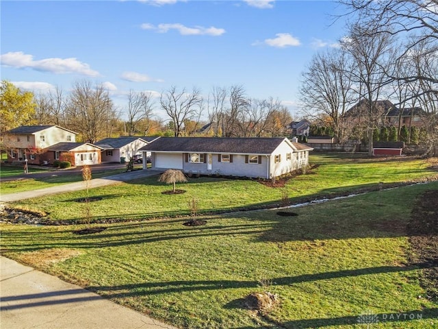 ranch-style home featuring a garage and a front yard