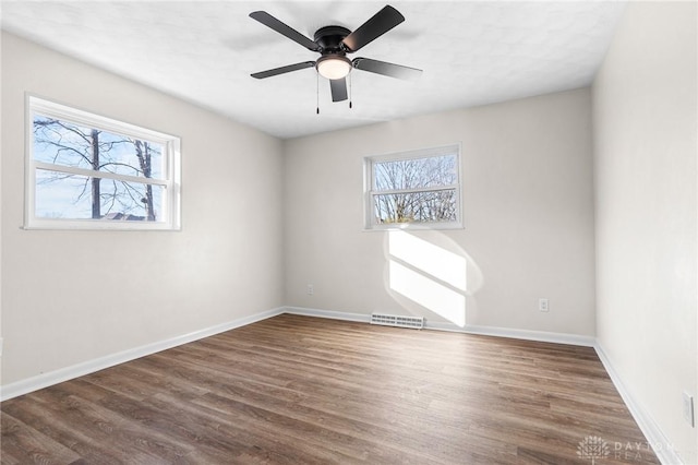 unfurnished room featuring dark hardwood / wood-style flooring and ceiling fan