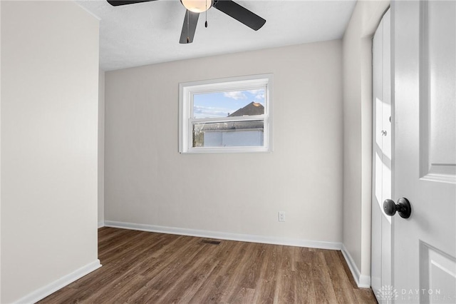 unfurnished room with ceiling fan and hardwood / wood-style flooring