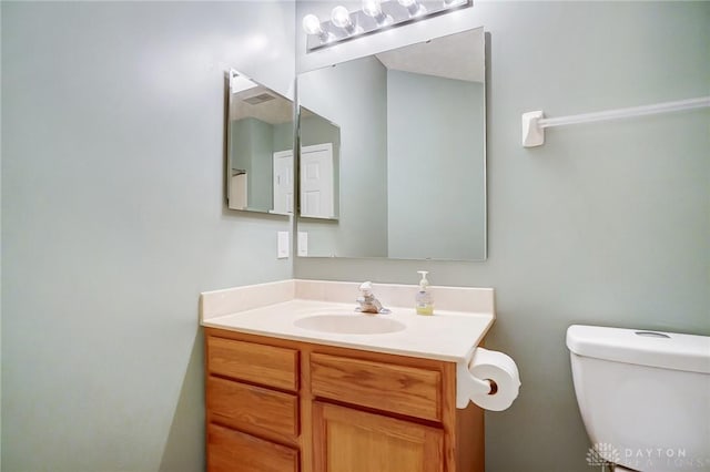 bathroom featuring vanity and toilet