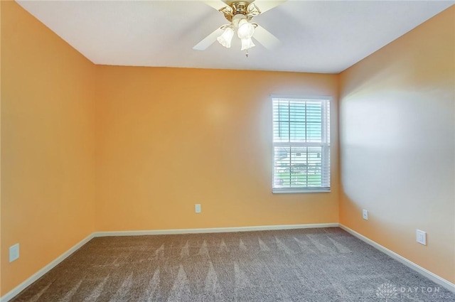 spare room featuring ceiling fan and carpet floors