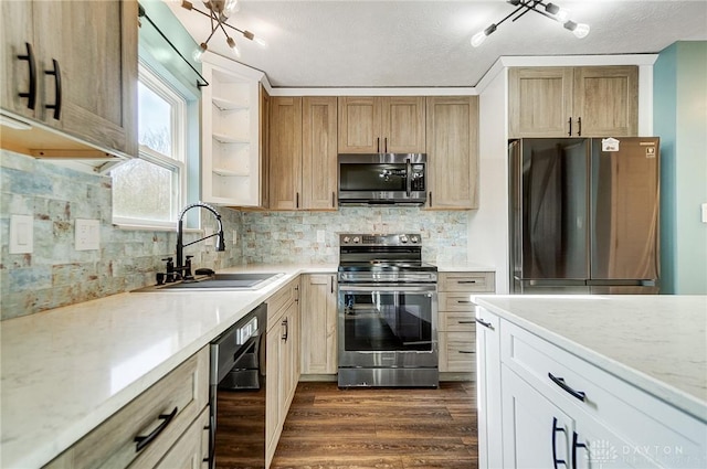 kitchen featuring decorative backsplash, appliances with stainless steel finishes, a textured ceiling, dark wood-type flooring, and sink