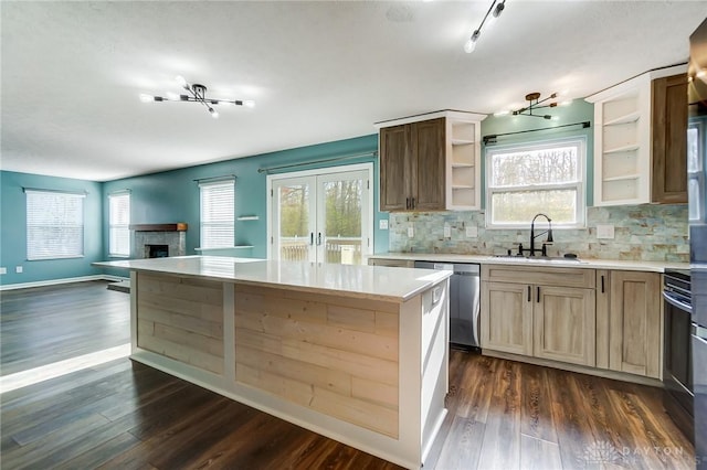 kitchen with dishwasher, dark hardwood / wood-style flooring, sink, and a wealth of natural light