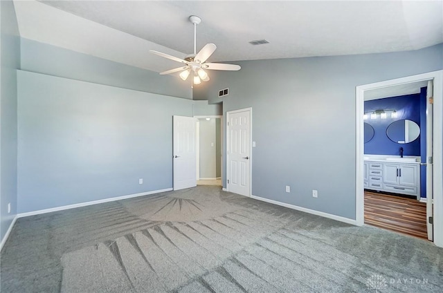 unfurnished bedroom with ceiling fan, lofted ceiling, and carpet floors