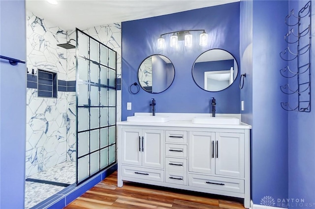 bathroom with vanity, hardwood / wood-style flooring, and walk in shower