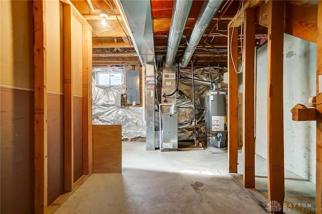 basement with gas water heater, electric panel, and heating unit