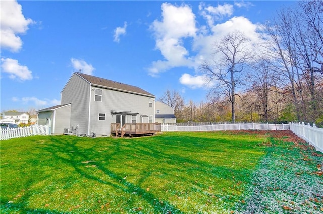 back of property with a lawn and a wooden deck