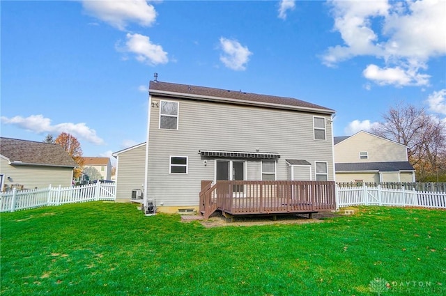 rear view of property with a yard and a wooden deck