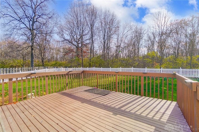 wooden terrace featuring a yard