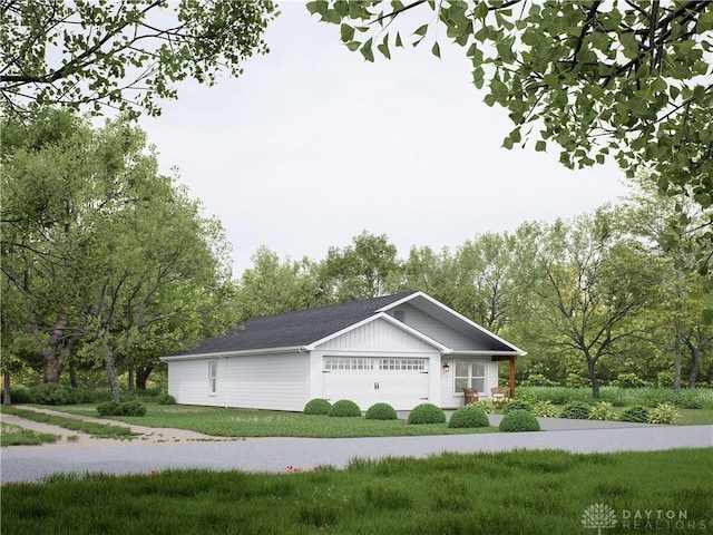 view of side of home featuring a lawn and a garage