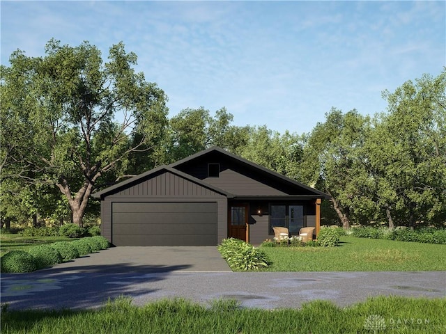 118 Arthur Ave, Carlisle, OH 45005 - view of front facade featuring driveway, a garage, a front yard, and board and batten siding