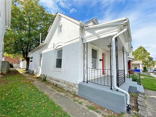 view of side of home featuring a porch