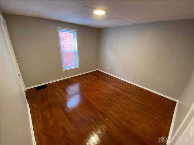 unfurnished room featuring dark wood-type flooring