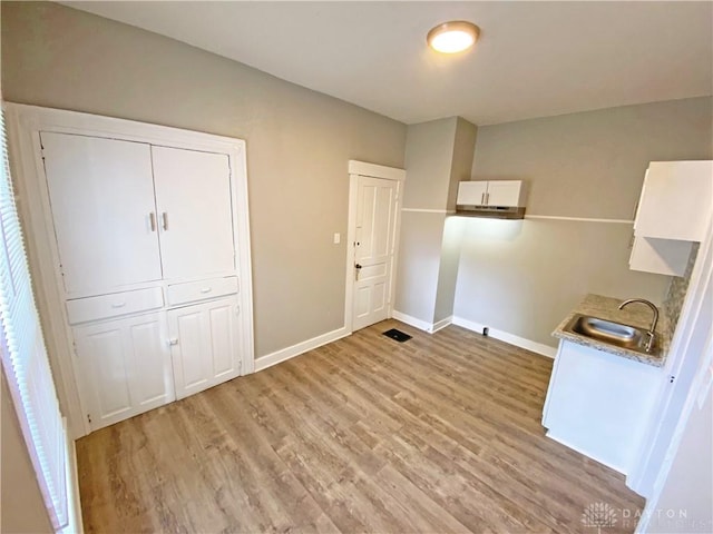 interior space with light hardwood / wood-style floors and sink