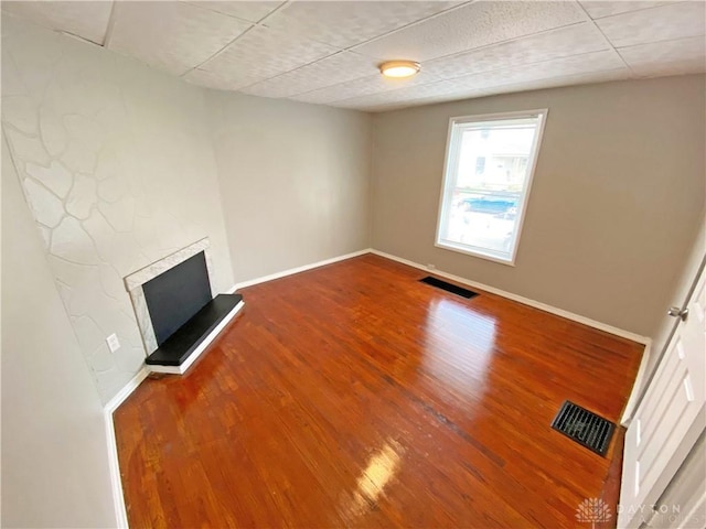 unfurnished living room with hardwood / wood-style floors