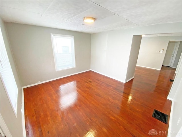 unfurnished room featuring dark wood-type flooring