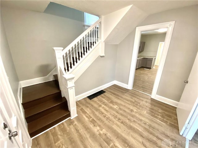 stairway featuring hardwood / wood-style floors