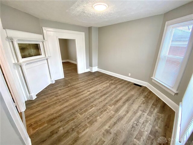 interior space featuring hardwood / wood-style flooring and a textured ceiling