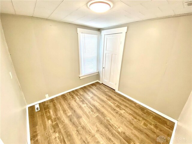 empty room with hardwood / wood-style flooring