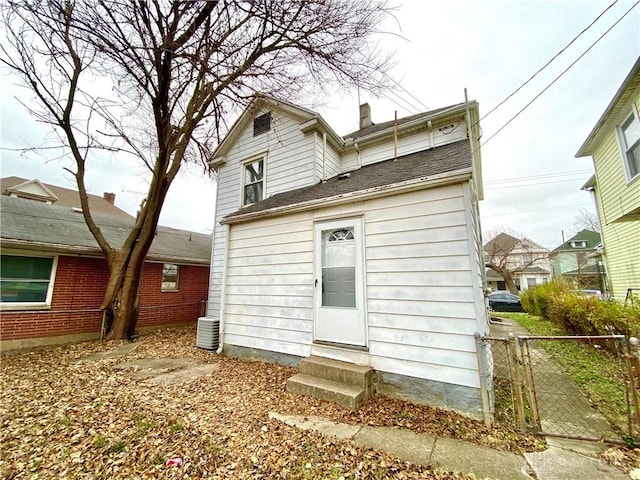 rear view of house featuring central air condition unit