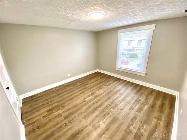 spare room with hardwood / wood-style flooring and a textured ceiling