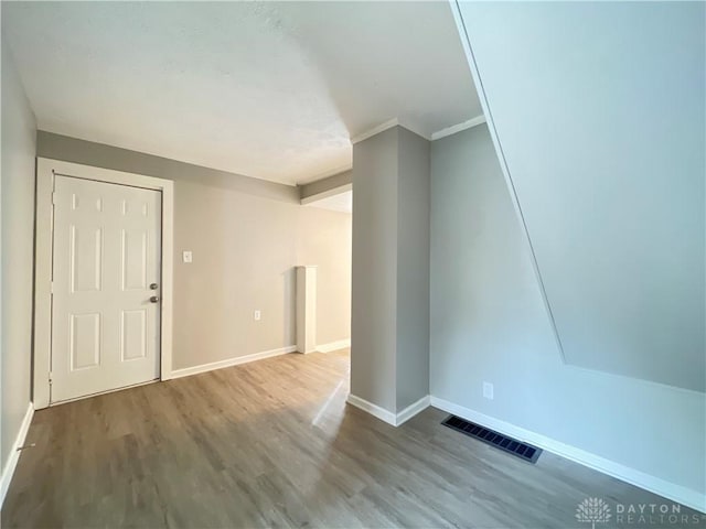 foyer entrance with hardwood / wood-style flooring and ornamental molding