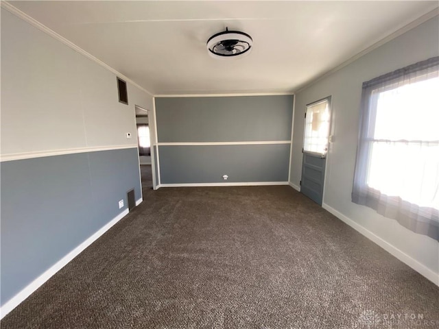 unfurnished room with dark carpet and crown molding