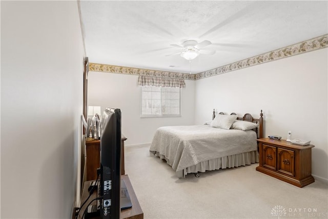 bedroom featuring ceiling fan and carpet