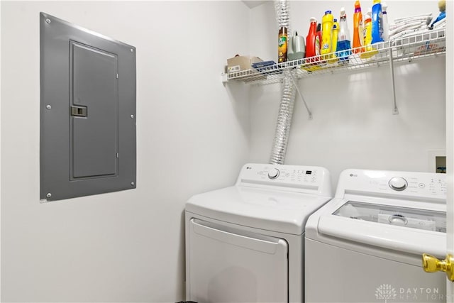 washroom with independent washer and dryer and electric panel