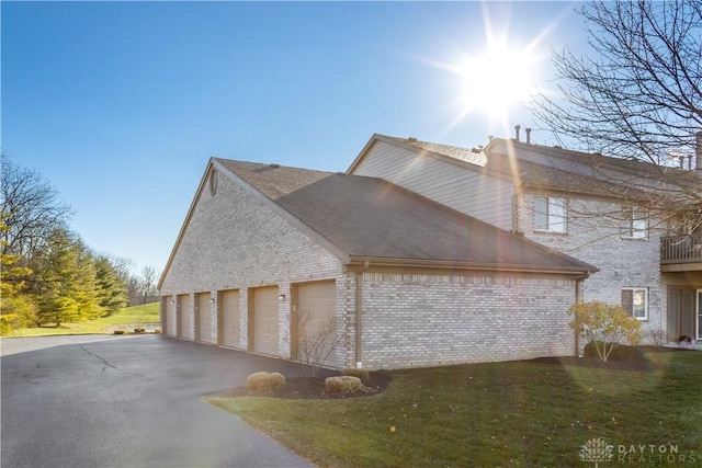 view of side of property with a garage and a yard