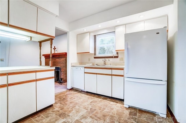 kitchen featuring white cabinets, white appliances, and sink