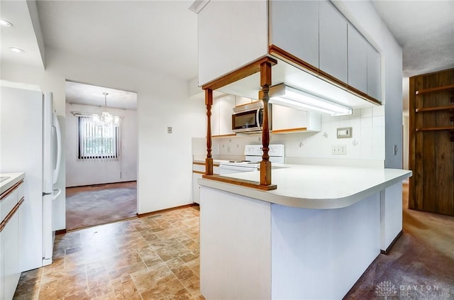 kitchen featuring white cabinetry, kitchen peninsula, pendant lighting, white appliances, and light carpet