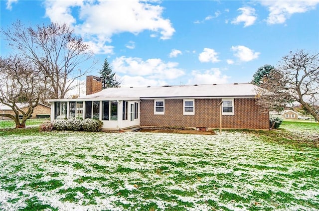 back of house featuring a sunroom and a yard