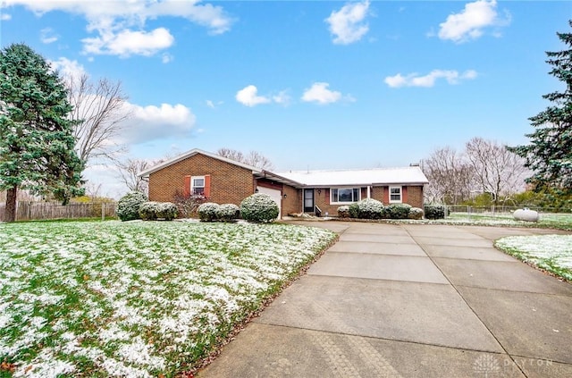 single story home featuring a garage and a front yard