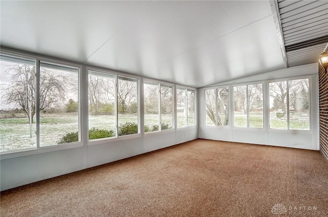 unfurnished sunroom featuring lofted ceiling