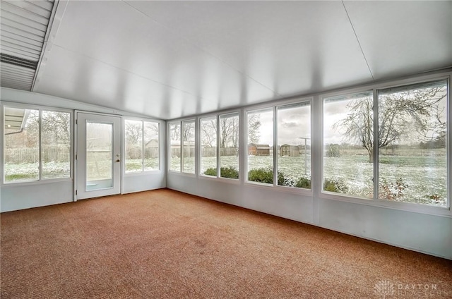 unfurnished sunroom featuring a water view and lofted ceiling