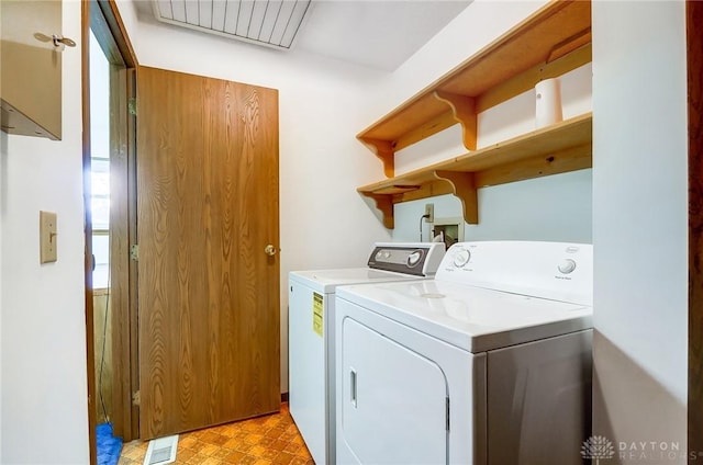 clothes washing area featuring washer and clothes dryer