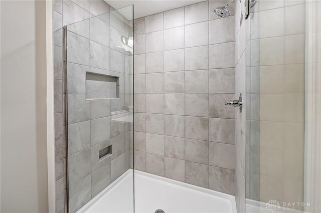 bathroom with a tile shower