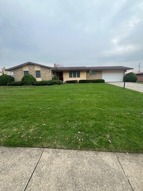 single story home with a front yard and a garage